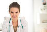 Portrait of smiling medical doctor woman sitting in office