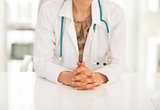 Closeup on medical doctor woman sitting in office