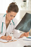 Medical doctor woman with fluorography working in office