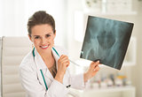 Portrait of happy medical doctor woman holding fluorography
