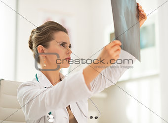 Medical doctor woman looking on fluorography