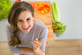 Portrait of smiling young housewife in kitchen