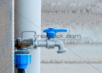 Frozen faucet in winter