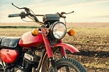 Classic old motorcycle on a dirt road.