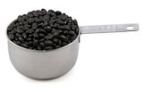 Black turtle beans in a cup measure