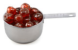 Sticky whole glace cherries in a cup measure