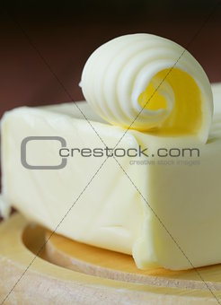 fresh yellow butter served on a wooden board