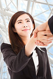 smiling business woman shaking hands in the office building