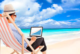 businessman sitting on beach chairs and look stock financial