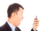 businessman screaming  into  smart phone over white background