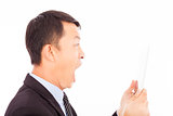 businessman  screaming into ipad or tablet over white background
