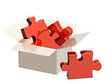 Parts of a puzzle in cardboard box