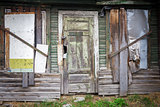 Boarded up windows and old door