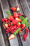 Fresh strawberry and redcurrant in a basket 
