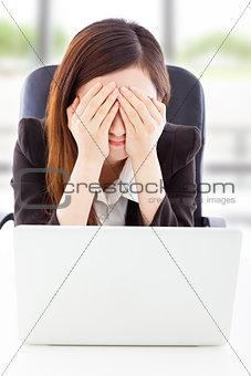 Young Business woman feel exhausted and cover her eyes