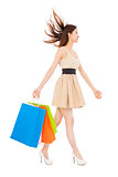 beautiful young woman with shopping bags and walking