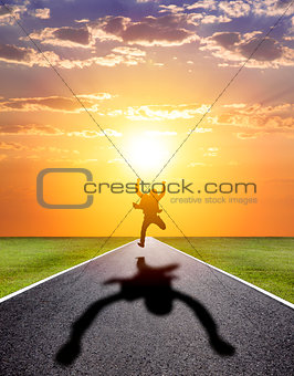 business man running happily to successful road with sunset