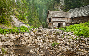 wooden cottage in the mountains with creek