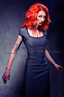 Portrait of a redhead woman with blood in her lips and neck indo