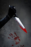 Female hand with bloody knife 