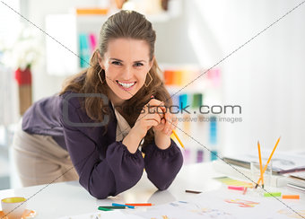 Portrait of smiling fashion designer in office