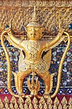 golden statue on wall in grand palace