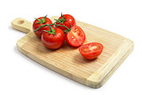 Fresh tomatoes on wooden chopping board  
