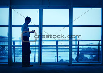 Silhouette of Asian Indian man texting