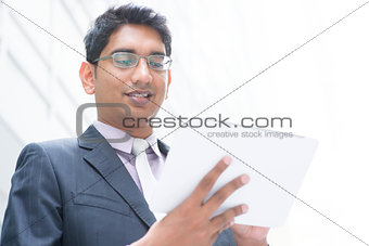 Indian businessman using computer tablet