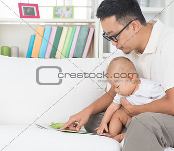 Father and baby reading story book