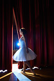 woman as classic dancer looking at stalls before ballet