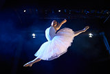 female classic dancer jumping mid air during ballet
