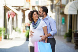 pregnant woman and man shopping in Italy