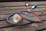 two badminton rackets on the old wooden table