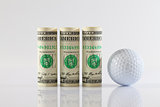 Rolls of dollar bills and golff ball 