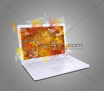 Open white laptop emits colored smoke