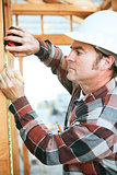 Construction Worker Takes Measurement