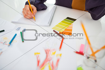 Closeup on fashion designer working in office