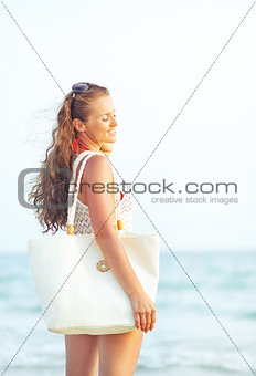 Young woman relaxing in the evening on beach