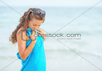 Young woman in towel at seaside