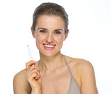 Happy young woman holding white pencil