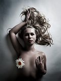woman with white flower of chamomile