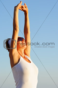 girl with arms raised towards the sky