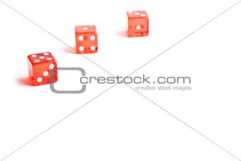  three red dice in a corner on white background