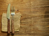 cutlery (knife and fork) on wooden background