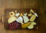cheeseboard with assorted cheeses (parmesan, brie, blue, cheddar)