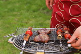 Cooking on the barbecue grill assortment sausages steak and skewers