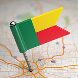 Benin Small Flag on a Map Background.