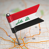 Iraq Small Flag on a Map Background.