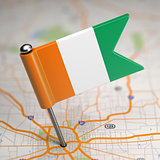 Cote d'Ivoire Small Flag on a Map Background.